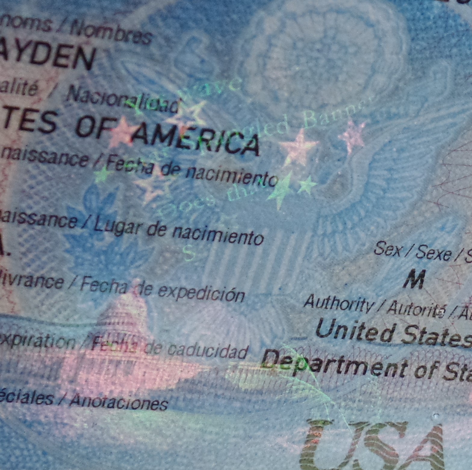 Hologram showing the capitol building, stars, grass, and 'say does that star spangled banner yet wave?' 